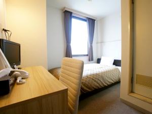 Säng eller sängar i ett rum på Hotel Trend Iwakuni