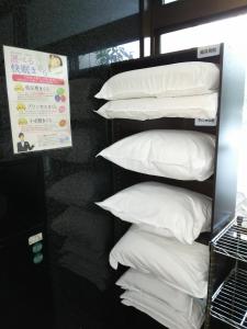a shelf with white pillows on top of it at Hirosaki Grand Hotel in Hirosaki