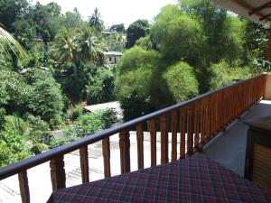 a balcony with a view of trees and bushes at Central City Hostel in Kandy