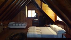 a attic bedroom with two beds in a cabin at Redgum Hill Country Retreat in Balingup
