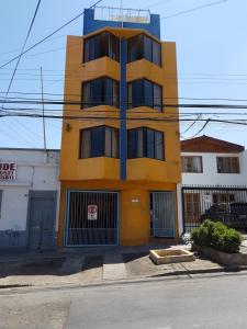 a yellow building on the side of a street at Resivic in Antofagasta