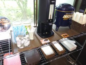 a coffee machine sitting on a shelf in a kitchen at Hirosaki Grand Hotel in Hirosaki +16 photos