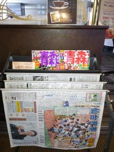 a stack of newspapers and a newspaper at Hirosaki Grand Hotel in Hirosaki