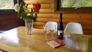 a table with two glasses and a bottle of wine at Vasiliou House Krimenos in Khandria