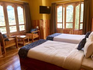 Postel nebo postele na pokoji v ubytování Hotel Khamsum