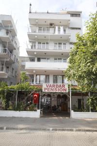 a large white building with a sign in front of it at Vardar Pension in Selçuk