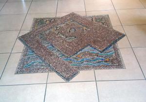 a rug on a tiled floor on a tile floor at Aeolian Gaea Hotel in Skala Kallonis