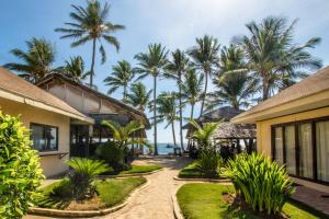 a beach with palm trees and palm trees at Levantin Boracay in Boracay