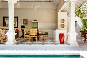 a kitchen and dining room with a pool at Villa Antiga 2 in Seminyak