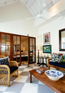 a living room with a couch and a table at Villa Antiga 2 in Seminyak