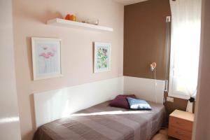 a bedroom with a bed in a room with a window at Laquilla II in Platja  d'Aro