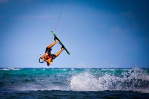a man on a surfboard in the air above the water at Levantin Boracay in Boracay