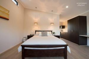a bedroom with a large bed in a room at Still Earth in Port Pirie