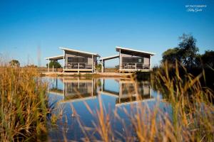 two houses are reflected in a body of water at Still Earth in Port Pirie
