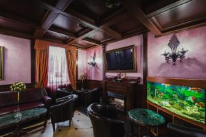 a room with chairs and a fish tank at Boutique Hotel Renaissance in Murmansk