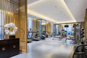 a gym with treadmills and exercise equipment in a building at Wanda Realm Dandong in Dandong
