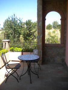 a patio with a table and chairs and a window at Garden B&B in Arezzo