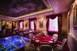 a dining room with a red table and chairs at Boutique Hotel Renaissance in Murmansk