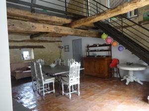 a dining room with a table and chairs at Lacoste B&B in Saint-Clair