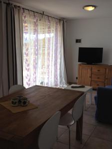 a dining room table with chairs and a large window at Brise Marine in Bonifacio