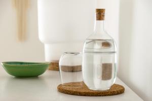 a bottle and a glass sitting on a table at Casa de Belharino in Miranda do Douro