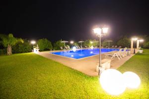 a swimming pool at night with a street light at B&B Il Giardino di Sicilia in Case Monterosso