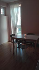 a table and chairs in a room with a window at Amelia in Świnoujście