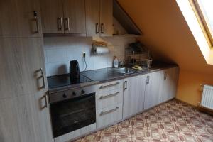 a small kitchen with a sink and a stove at Kamparkalns in Talsi