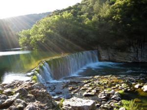 a waterfall with a person standing on top of it at Gite du Boulidou in Cazilhac