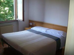 Łóżko lub łóżka w pokoju w obiekcie Hotel Valle Intelvi