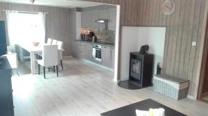 a kitchen and dining room with a table and a stove at Voss- Myrkdalen Lodge in Vossestrand