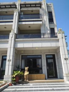 a building with a teddy bear in front of it at Wendy's home Toucheng Mansion A in Toucheng