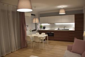 a kitchen and dining room with a table and chairs at Solankowa Aleja in Inowrocław