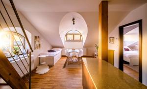 a room with a bed and a table in a room at Rooftop Triplex Apartment in Centre in Hradec Králové