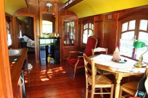 a kitchen and dining room with a table and chairs at les roulottes du LOT in Gramat