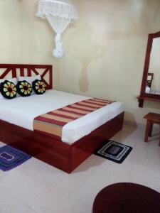a bedroom with a bed in a room at Ruins View Holiday Resort in Polonnaruwa