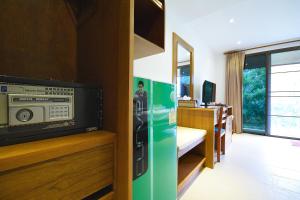 a room with a green refrigerator and a tv at Siam Sunrise Seaview in Chaweng