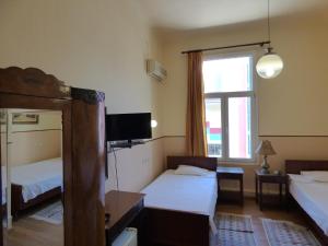 Postel nebo postele na pokoji v ubytování Hotel Acropolis