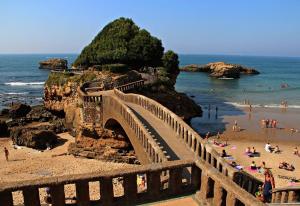 a bridge over a beach with people on the sand at Côte Landaise in Tarnos