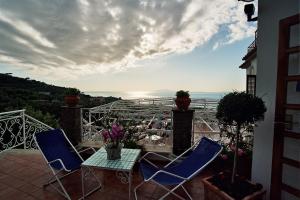 a patio with two chairs and a table on a balcony at Hotel Dania in Sorrento