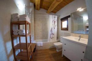 a bathroom with a sink and a toilet and a tub at Can Rovira de Fogars in Montseny