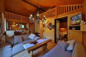 a living room with a couch and a table at Ferienhaus Mitterdorf in Philippsreut