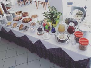 a table with plates of food on it at Hotel Mare Blu -- boutique in Pineto