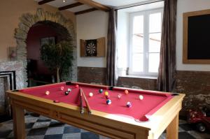 a pool table in a living room with at Gites "Aux Legendes d Ardenne" in Paliseul