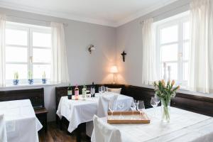a dining room with two tables with white tablecloths at Gästehaus Annemaria in Retz