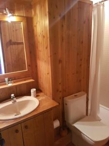 a bathroom with a sink and a toilet and a mirror at APARTAMENTO BOI TAULL IMMO 1 DORM. in Pla de l'Ermita