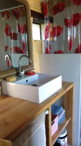 a bathroom sink with a mirror on a table at Maison Chaumont in Vézac +59 photos