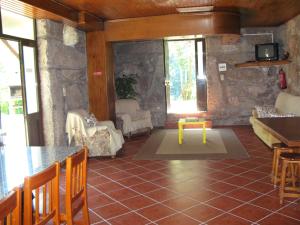 a living room with a table and some chairs at Campismo Rural Vale dos Moinhos Gerês in Geres