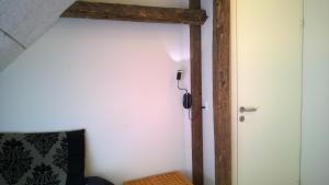um quarto com uma parede branca e um poste de madeira em Moselundgaard B/B og Hestehotel em Engesvang