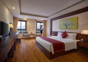 a hotel room with a bed and a desk and a television at Sapa Freesia Hotel in Sapa +111 photos